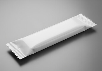 A single blank white rectangular food bar wrapper with sealed edges isolated on white background
