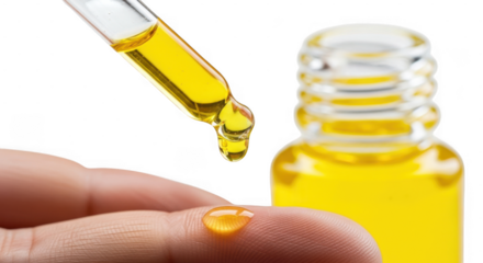 Closeup of hand using dropper to apply yellow oil from bottle, isolated on transparent background