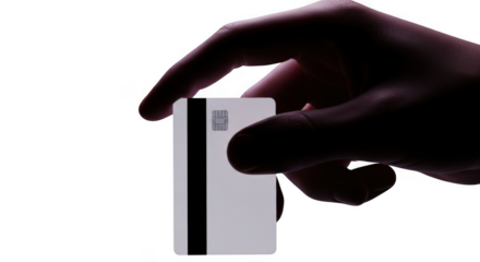 Hand holding a white card with magnetic stripe against dark background isolated on transparent background