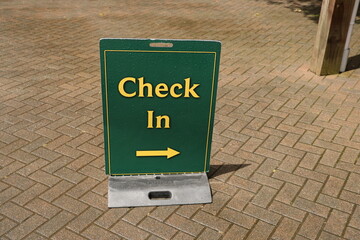 Check in sign on paved path