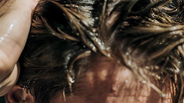 Overhead shower moment with fingers combing through soaked hair, silky suds sliding in ribbons; a sensorial beauty visual that sells cleanliness, hydration and the satisfying feel of a deep scalp clea