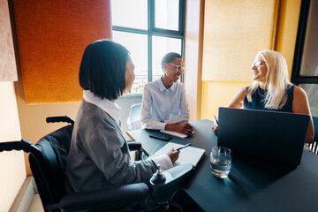 Team members engaged in a meeting in a modern office workspace
