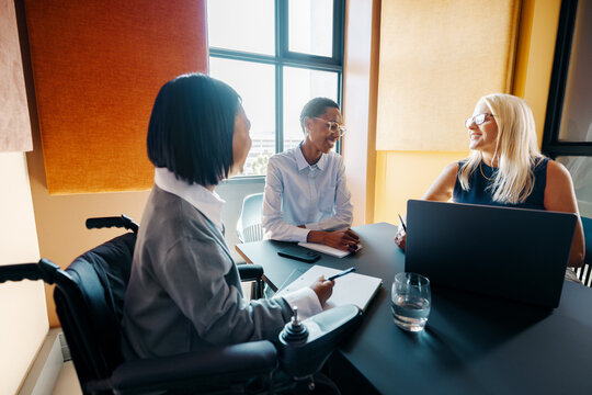 Team members engaged in a meeting in a modern office workspace