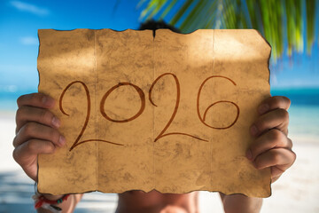 2026 Happy New Year .Tourist man with Santa Claus hat relaxing on tropical island beach. Punta Cana, Dominican Republic.
