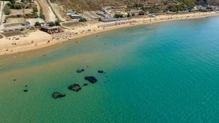 Obraz premium Aerial view of the beach and coastline of Siculiana Marina, in province of Agrigento, Sicily, Italy. It is a long sandy coast overlooking the Mediterranean Sea, whose waters are blue and turquoise.