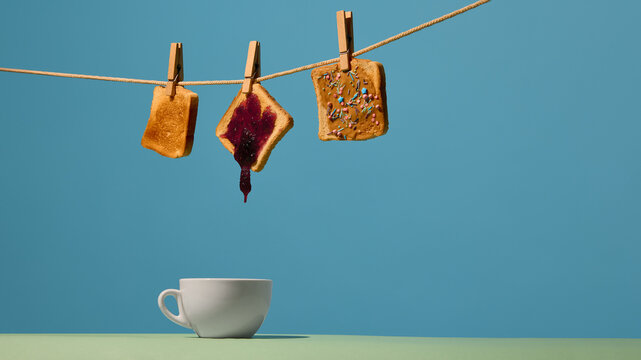 Toast with dripping jam suspended above cup on vibrant background. Concept of cafe branding, drink pairing ideas, menu updates, morning routine content and blog visuals.