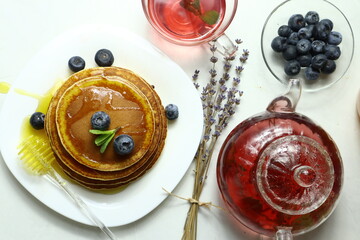 Tasty homemade pancakes with honey and berries