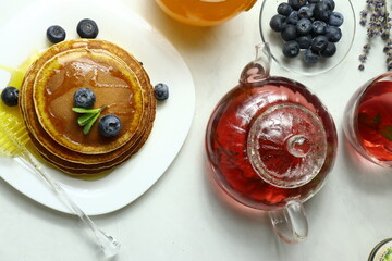 Tasty homemade pancakes with honey and berries