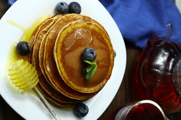 Tasty homemade pancakes with honey and berries