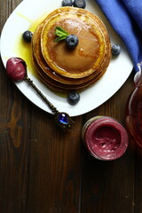 Tasty homemade pancakes with honey and berries