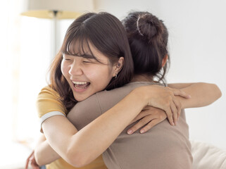 Happy asian girls embraced in a friendly hug