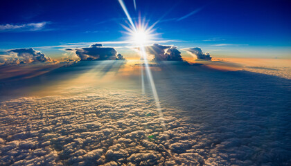 Intense sunbeams and starburst effect over a dense blanket of cumulus clouds viewed from high altitude.