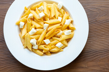 Close-Up of Penne Pasta with Cubed Cheese