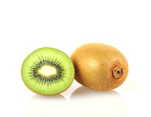 Fresh kiwi fruit halved with vibrant green flesh on white surface