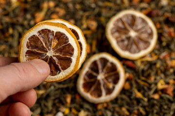 green tea with added flavors and pieces of fruit and cut dried yellow lemons, bright large dry lemon slices and green tea with pieces of fruit