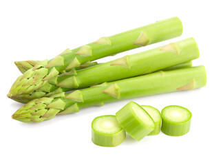 Fresh asparagus spears displayed with cut pieces on white surface