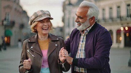 Happy senior couple having fun outdoor with city in background - Love, relationship and joyful elderly lifestyle concept - Models by AI generative