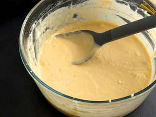 Close up of fresh raw dough for waffles or pancakes in a glass bowl 