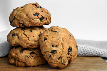 Close up photo stack delicious cookies with raisins and nuts on light background. Homemade baking....