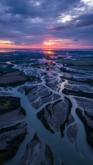 Dramatic sunset lights up the braided river, creating an awesome landscape, perfect for travel blogs and environmental conservation campaigns