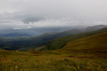 Summit of Ben Nevis in Scotland with misty clouds rolling over the rocky peak, capturing dramatic mountain atmosphere and shifting highland weather.