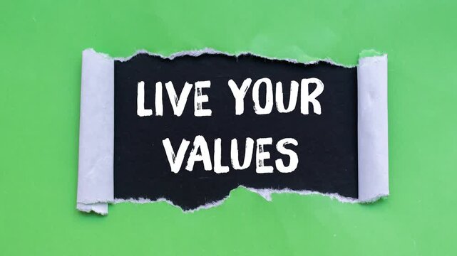 Live your values message writing on ripped torn paper background