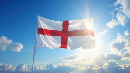 England flag, st. George's cross, waving with sun shining in bright blue sky.