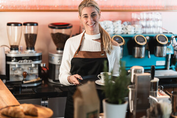 A smiling waitress behind the counter welcomes customers with warm service in a modern inviting cafe atmosphere