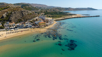 Obraz premium Aerial view of the beach and coast of Siculiana Marina, in province of Agrigento, Sicily, Italy. It is a small coastal village overlooking the Mediterranean Sea, whose waters are blue and turquoise.