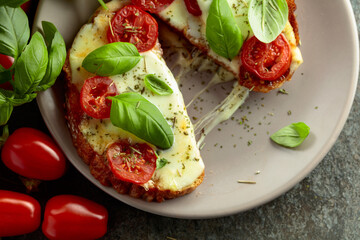 Hot open sandwiches with mozzarella, tomatoes and basil.