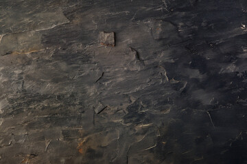 Textured dark slate stone background with natural minerals
