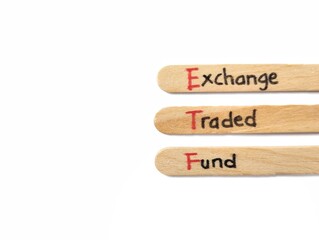 The word ETF (Exchange, Trade, Fund) on wooden craft stick on white background. Copy space 