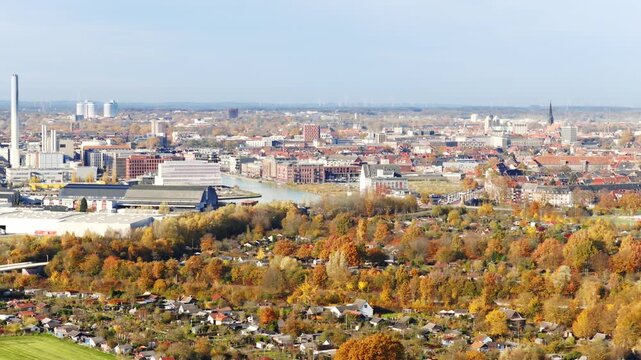 Autumn panorama of M&uuml;nster, showing industrial areas, the harbor basin and the city&rsquo;s distinctive church spires rising in the distance.