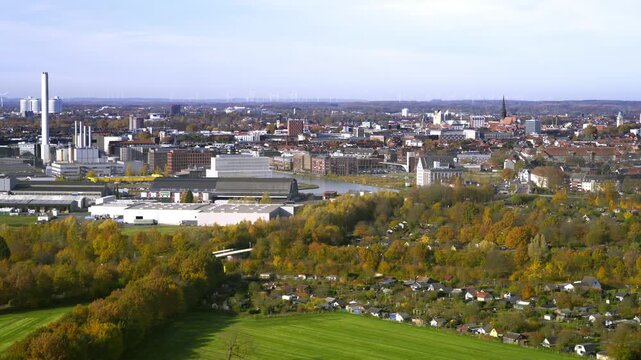 Autumn panorama of M&uuml;nster, showing industrial areas, the harbor basin and the city&rsquo;s distinctive church spires rising in the distance.