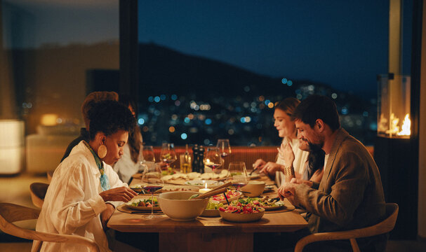Friends dining together at a cozy evening dinner in a modern home