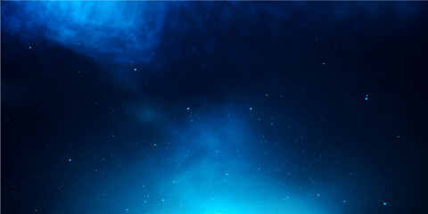 Bright blue night sky with glowing stars and abstract clouds illuminates the deep space of the universe with a supernova and distant galaxy © PIXEL GLOW