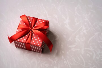 Festive red polka dot gift box tied with a satin ribbon