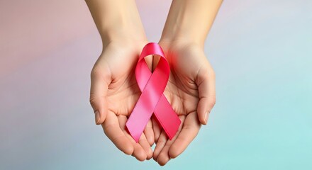 Hands Holding Pink Ribbon for Breast Cancer Awareness and Support Campaign