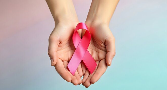 Hands Holding Pink Ribbon for Breast Cancer Awareness and Support Campaign