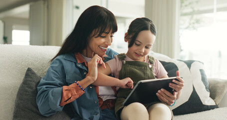 Bonding, learning or tablet with mother and daughter on sofa in living room of home for development. App, education or reading with girl child and single parent woman in apartment for elearning