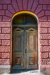 old wooden door in a brick wall