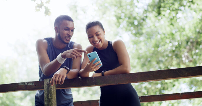 Hiking, happy couple and phone on outdoor bridge, digital map or location for trail navigation. Fitness exercise, below or people pointing with flare in nature, fauna and flora research on mobile app