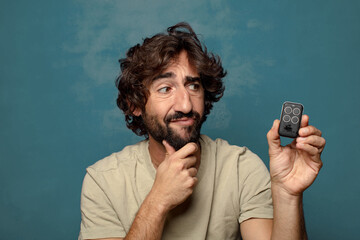 young adult bearded man with a garage remote control
