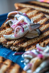 Alici in saor, marinated anchovies with red onions.