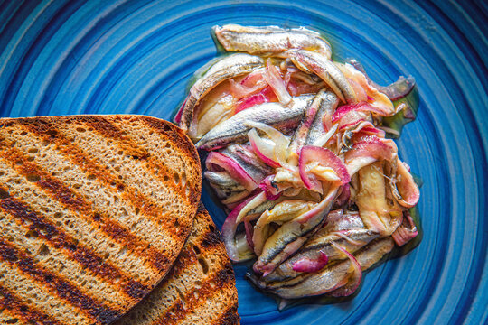 Alici in saor, marinated anchovies with red onions.
