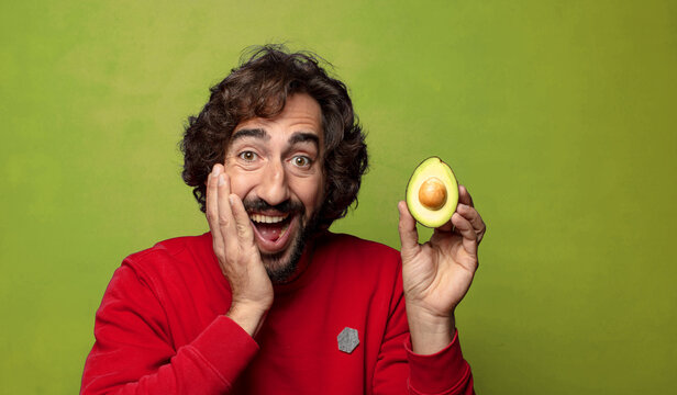young adult bearded man with an avocado