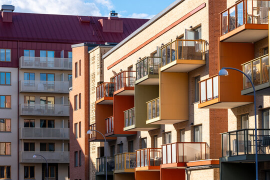 Warm-toned architecture with rhythmic housing balconies defining an urban zone of contemporary sweden, stockholm, stora ursvik enriched by residential facade contrast