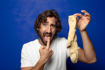 young adult bearded man with a dirty sock