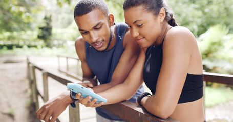 Internet, outdoor and couple with cellphone, fitness and bonding together with social media. Nature, man and woman with smartphone, website info and digital app to track progress, text and connection