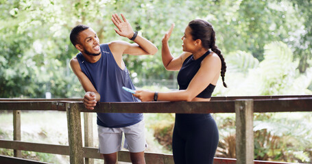 Man, woman and high five with personal trainer at park with success, achievement and training target. People, celebration and coach with support, motivation and goals with exercise in Costa Rica